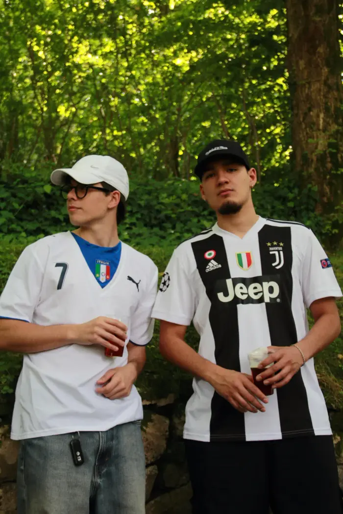 Two people wearing an Italy shirt and a Juventus shirt
